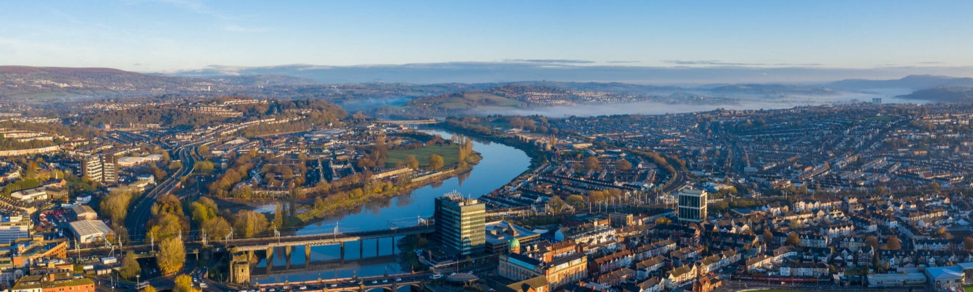 An aerial view at sunrise of Newport city centre, south wales United Kingdom, taken from the River Usk