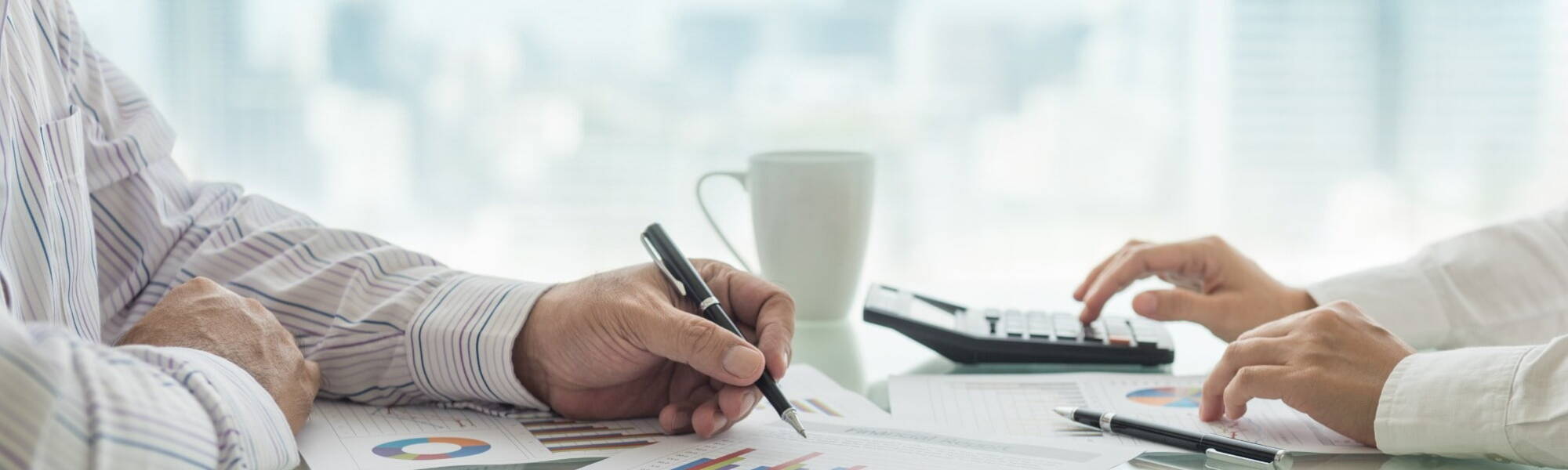 hands with pen signing document