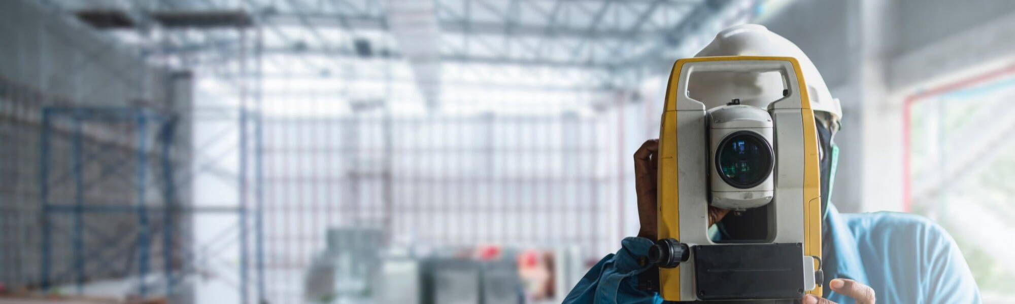 A quantity surveyor measuring a construction site